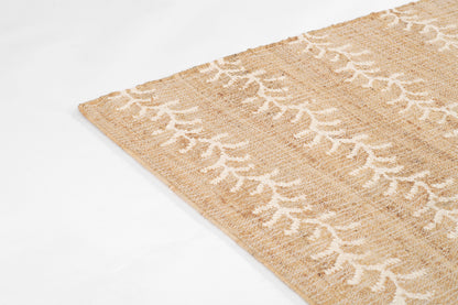 Beige jute rug with white vine stripe pattern; natural textured, boho floor decor.