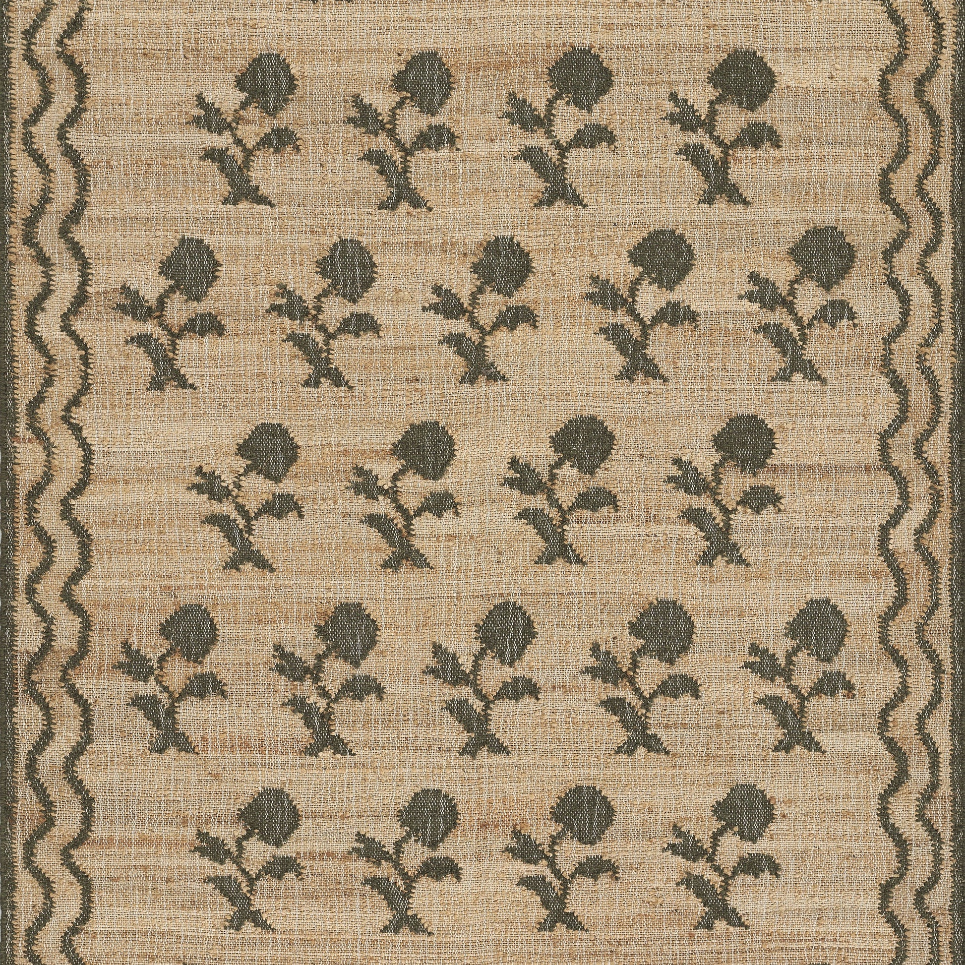 Beige woven runner with repeating gray flower motifs and scalloped dark borders along the edges, 2'3" x 8'.