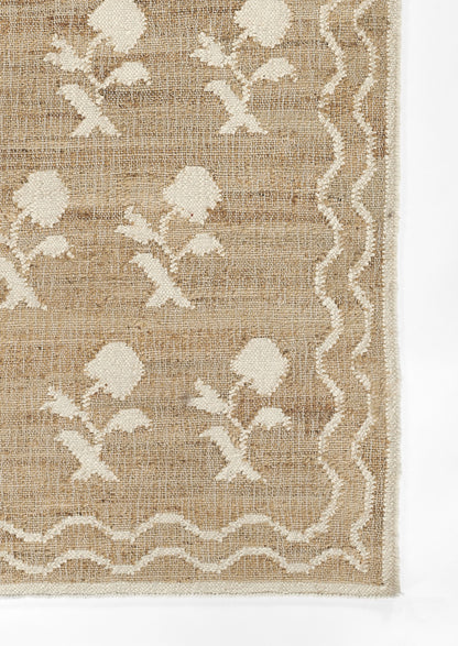 Natural jute rug with cream floral motifs and scalloped border; beige/tan tones, rustic farmhouse style area rug.