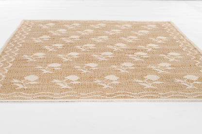 Beige jute rug with white flower motif and lattice pattern; rectangular natural fiber rug for casual coastal decor.