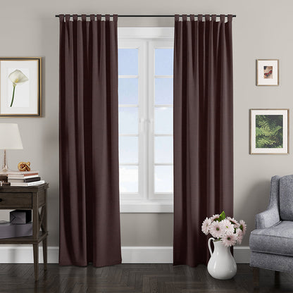 Deep plum textured fabric curtain panel with grommets on a dark rod, in a cozy living room with a gray sofa, vase of flowers, and framed art.
