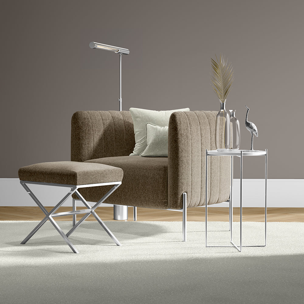 Brown textured fabric upholstery on seating in a modern living room, with chrome legs and glass side tables with vases.
