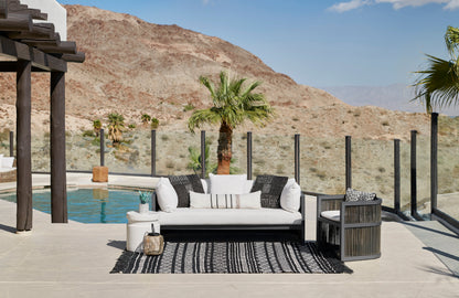 Outdoor rug, 4' x 6', laid poolside in a desert hillside setting.