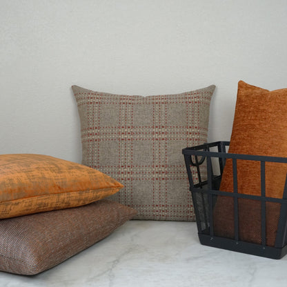 24" x 24" Spice Solid cuddle pillow with soft textured fabric, shown with orange and brown pillows & a black metal wire basket.