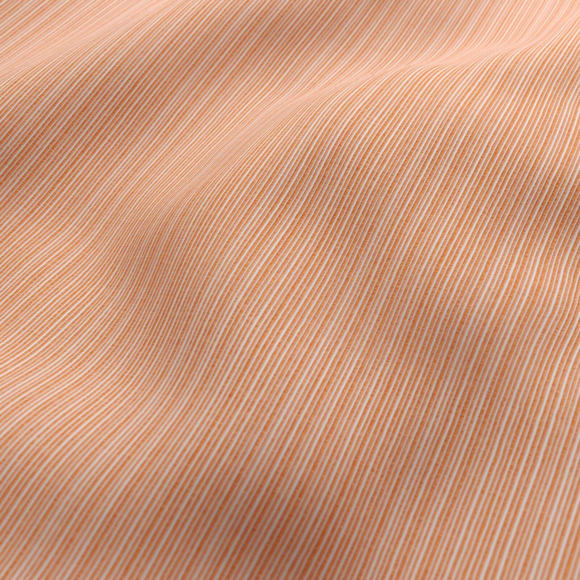 Orange and white striped outdoor fabric with a soft drape.