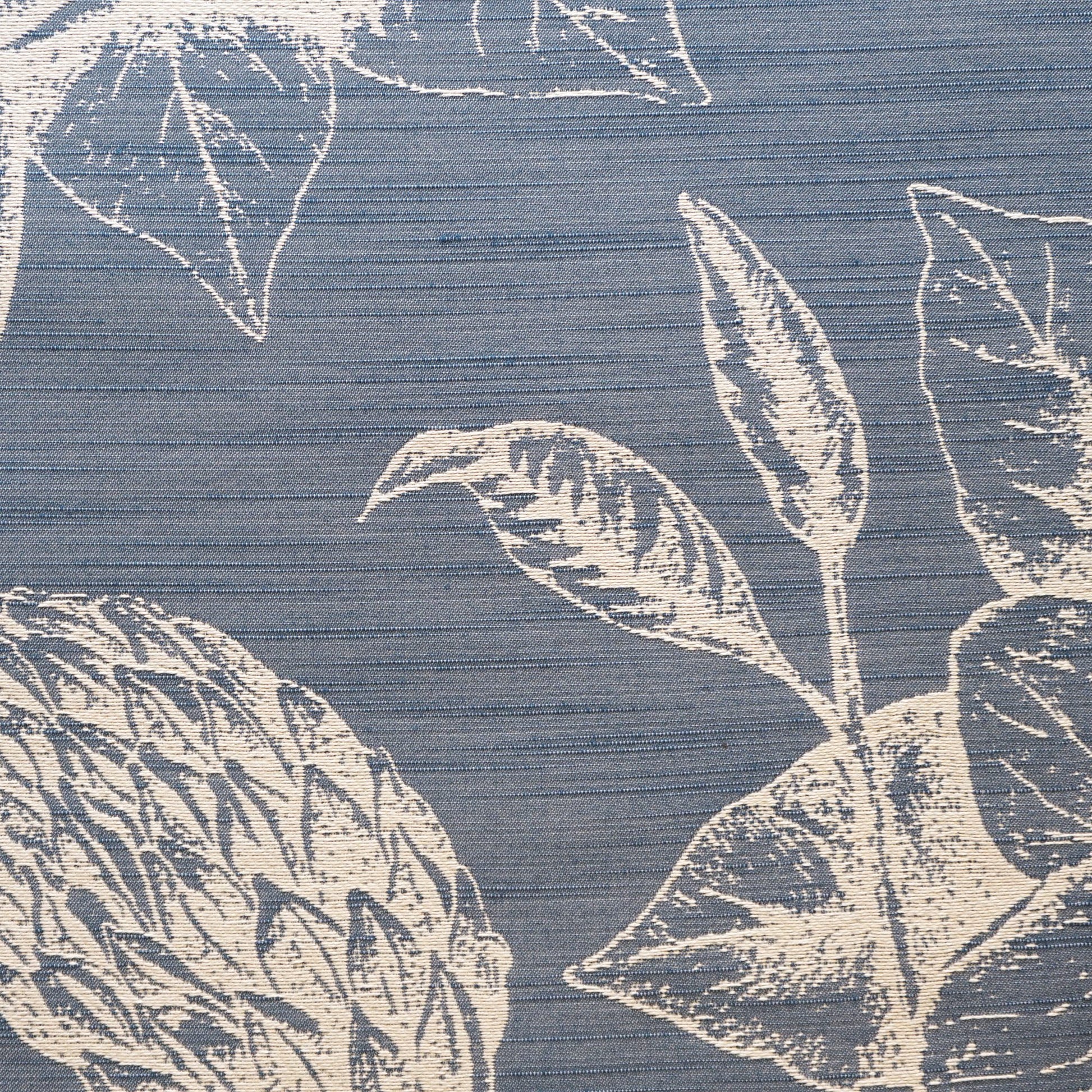 Blue woven jacquard fabric with a large white botanical leaf pattern and horizontal texture.