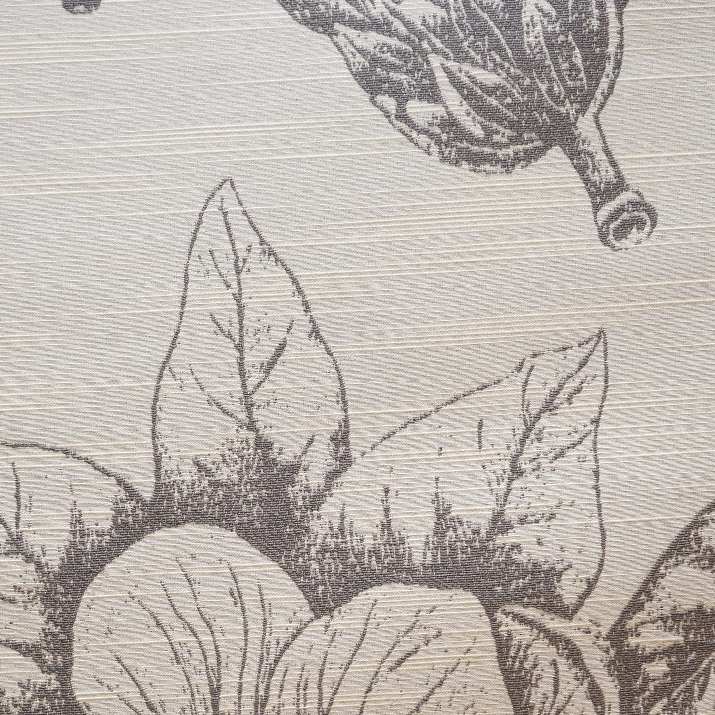 Beige fabric with a gray botanical print featuring large veined leaves and round fruit.