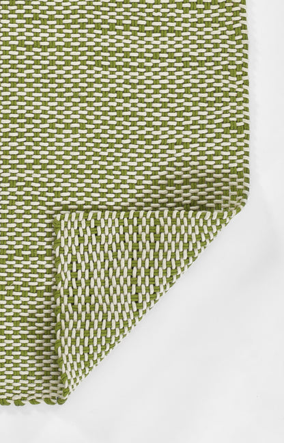 Olive green and white woven rug runner with basketweave texture and folded corner, 3' x 8'.