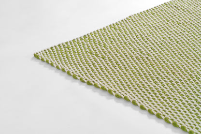 Rectangular woven rug in white with lime-green loop texture.