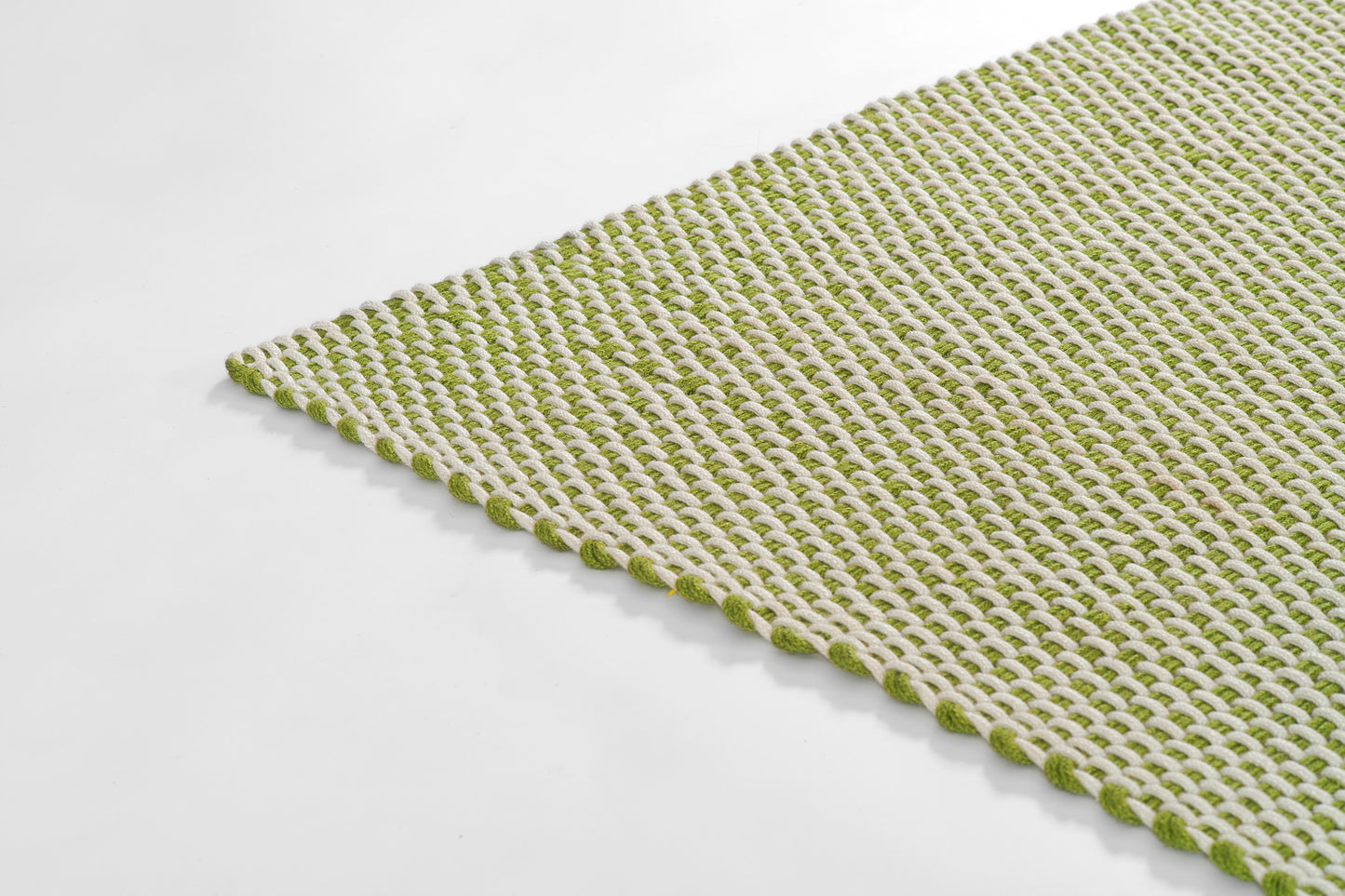 Green and white woven paracord rug with looped border, textured for kitchen or bathroom.