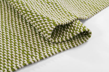 Olive green and off-white woven rug with chunky braided texture, rectangular rug.