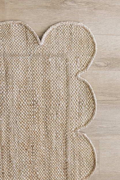 Natural beige woven runner with scalloped border and boucle texture; rustic boho-style runner.