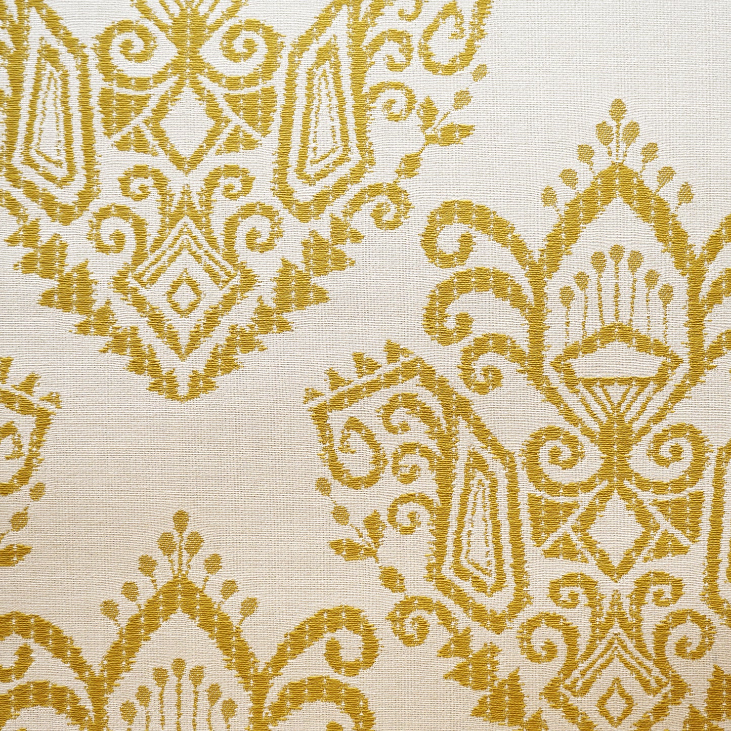 Green ikat jacquard fabric with a woven pattern and subtle texture.