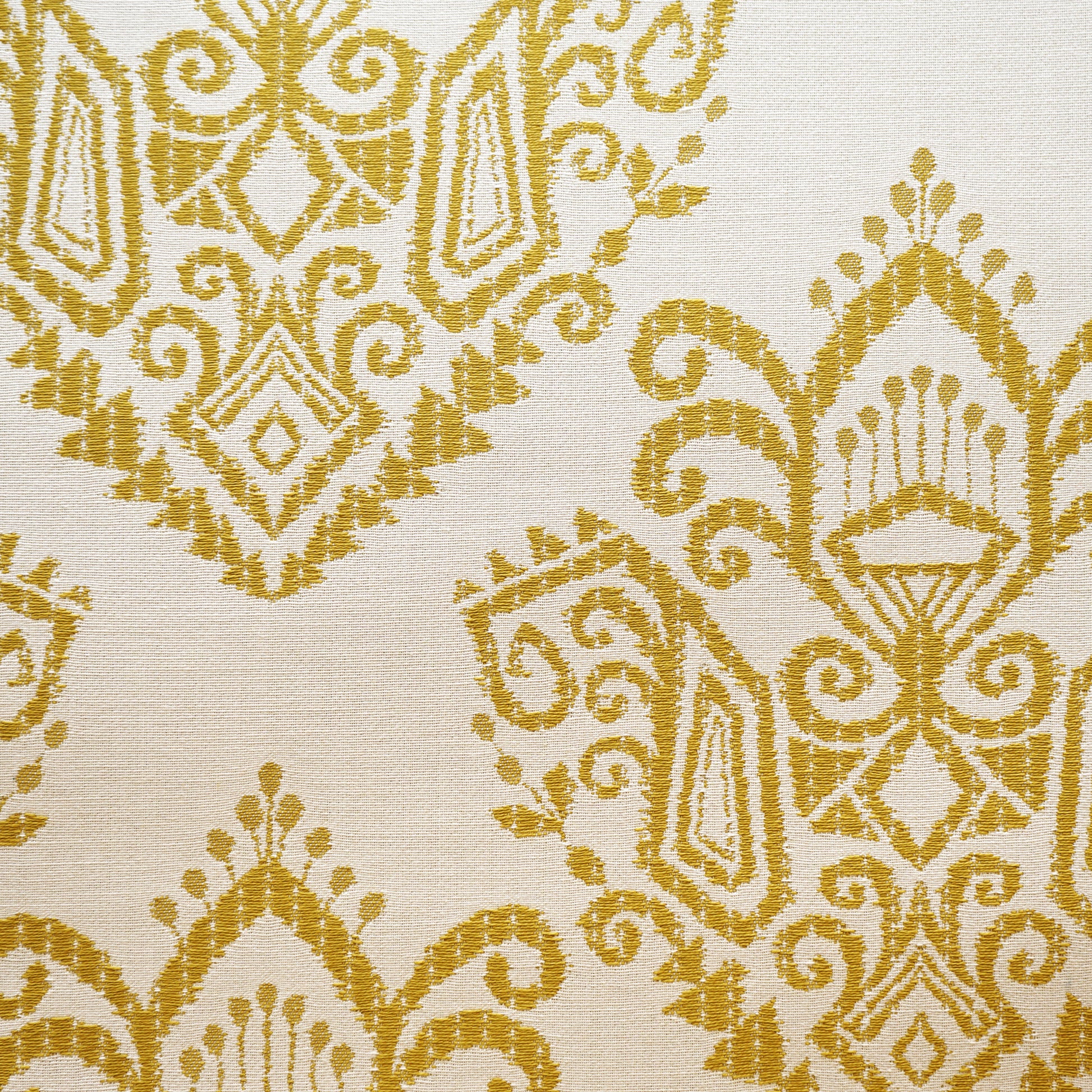 Green ikat jacquard fabric with a woven pattern and subtle texture.
