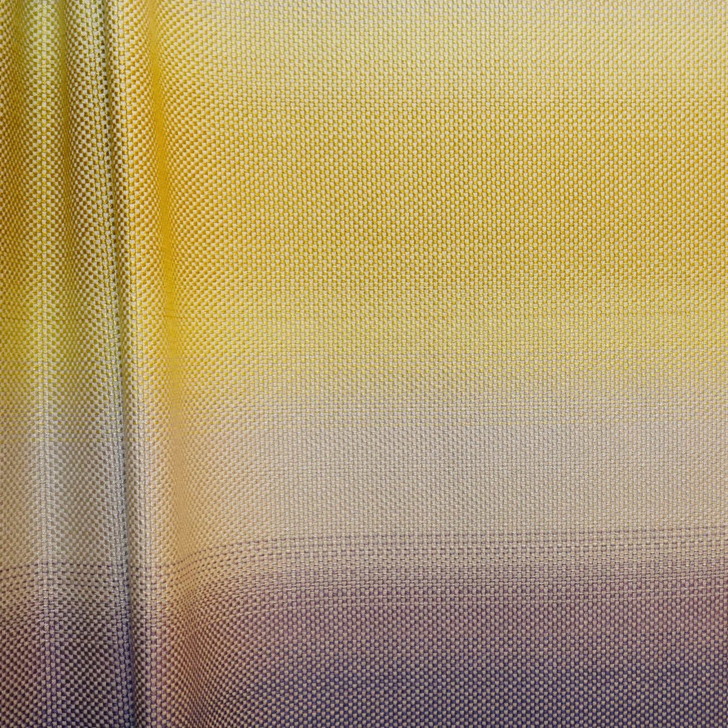 Gradient yellow-to-gray jacquard fabric with a dotted texture; close-up.
