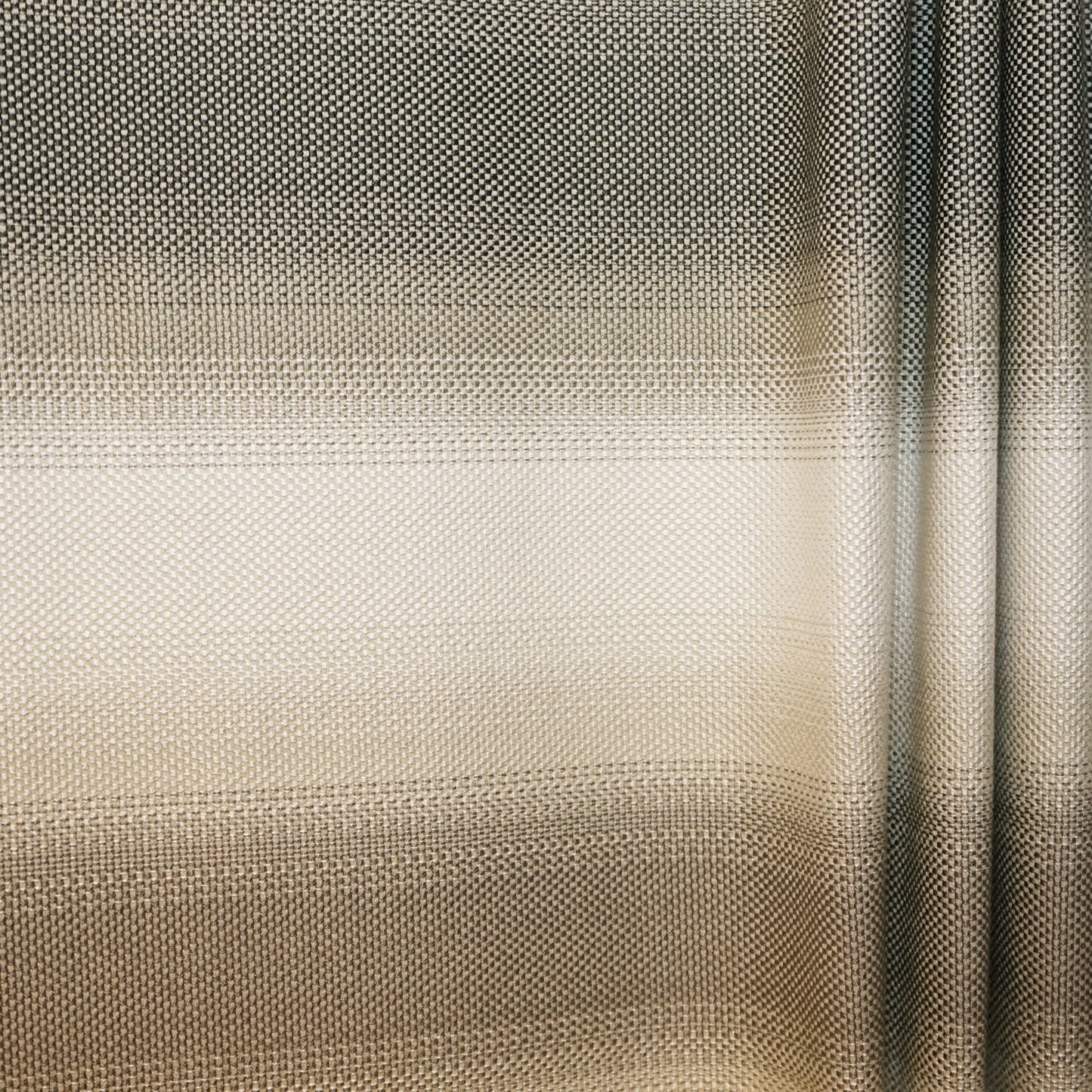 Close-up of fabric showing an ombre beige-to-taupe gradient with a striped jacquard texture.