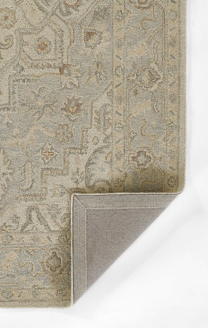 Neutral woven Persian-style rug in ivory, gray and taupe with arabesque pattern; corner folded to reveal backing.