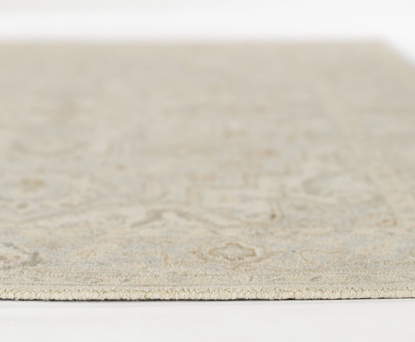 Cream-beige patterned area rug with a subtle motif, low pile, rectangular, ideal for living room or bedroom.