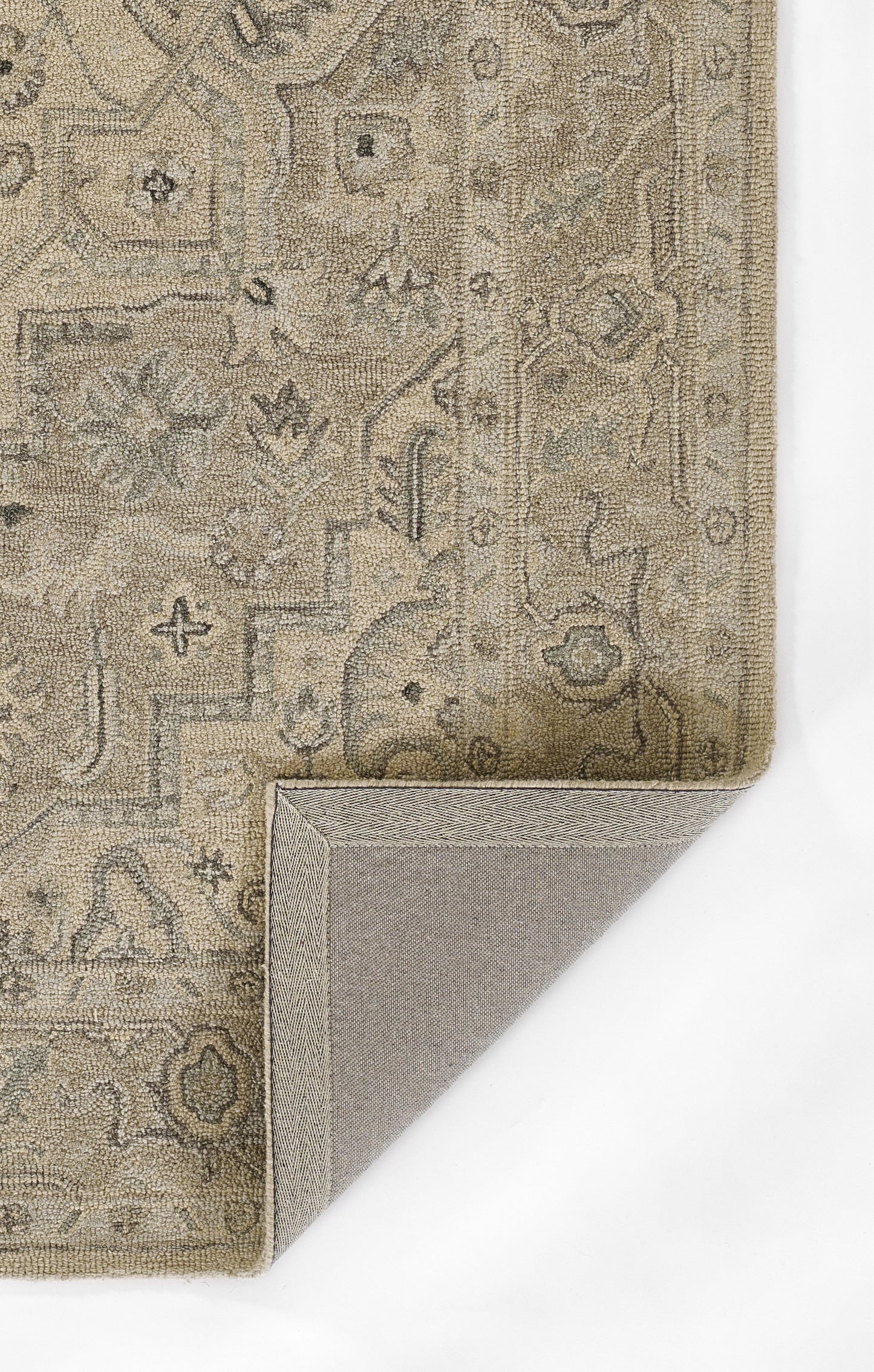 Taupe Persian-style rug with muted cream floral medallions; distressed antique look, folded corner visible.