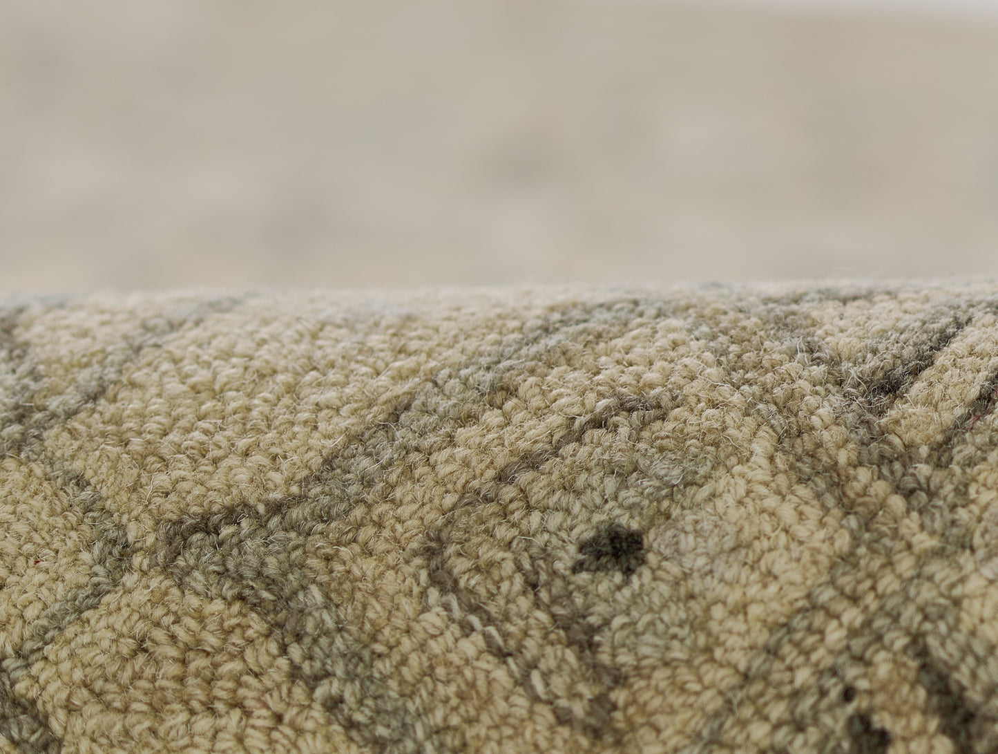 Beige-taupe geometric rug with looped pile; close-up texture and pattern.