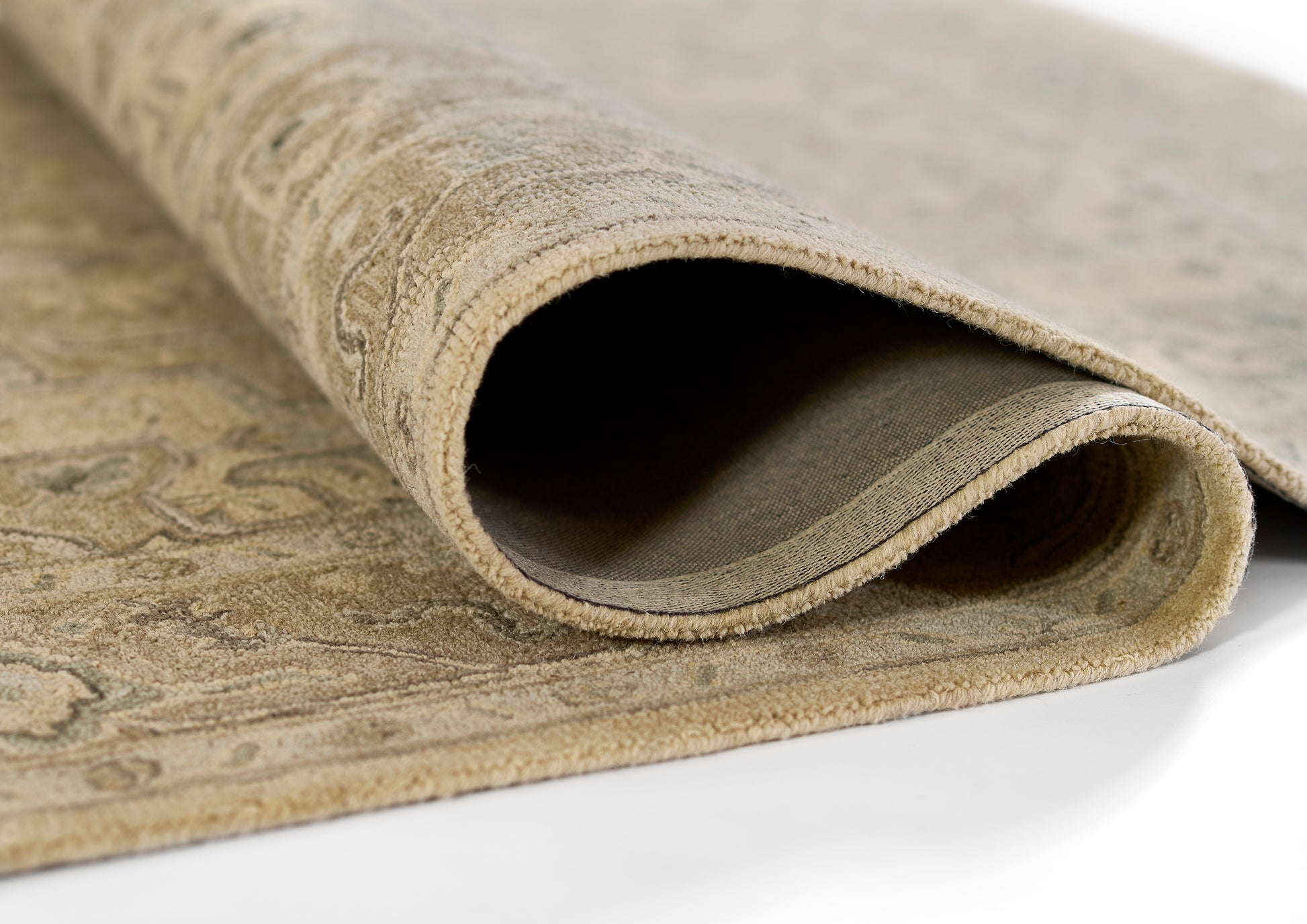 Taupe Persian-style runner rug, rolled at the edge, plush pile with ornate beige patterns.