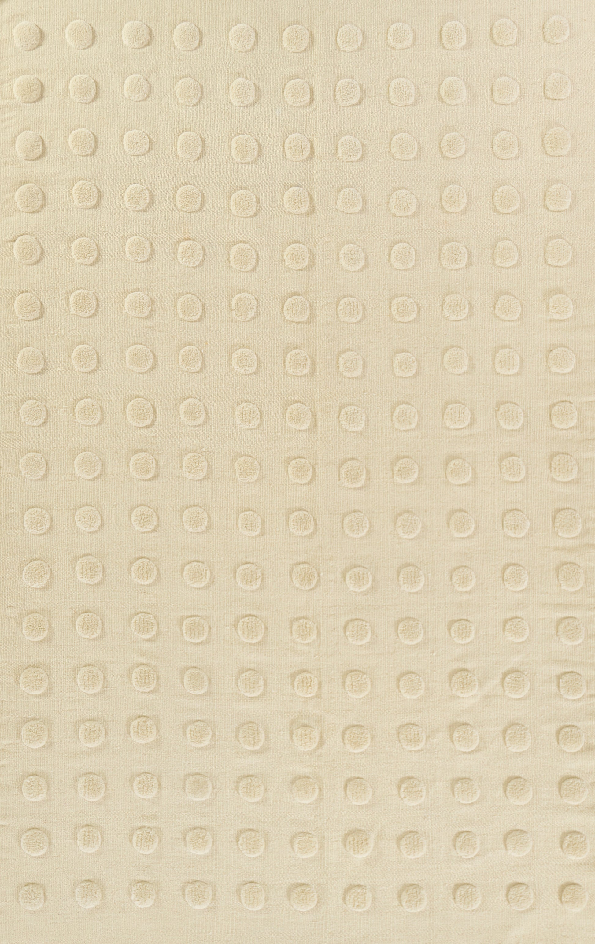 Beige fabric with tiny raised circular dots in a neat grid, soft texture for upholstery or wallpaper.
