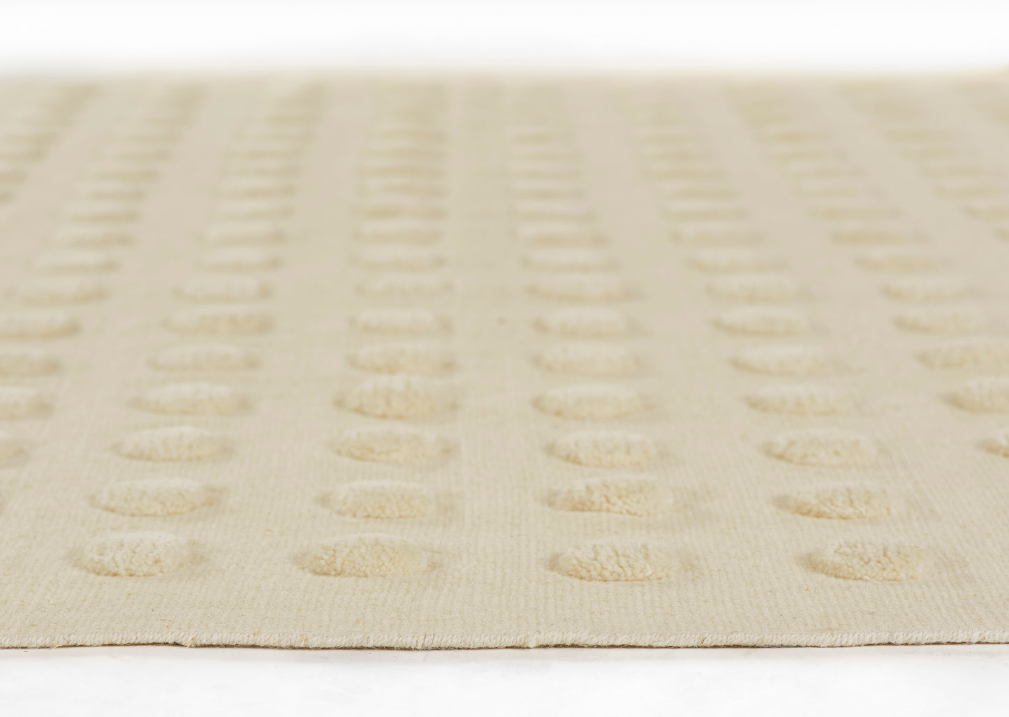 Beige rug with repeating tan circular dot pattern; flat, low-pile weave for modern living room decor.
