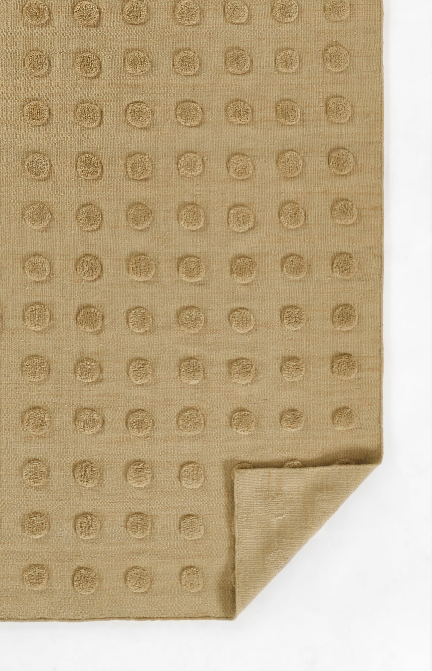 Taupe fabric with a raised circular dot grid pattern, folded corner; soft towel or napkin.