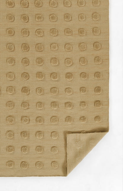 Taupe fabric with a raised circular dot grid pattern, folded corner; soft towel or napkin.