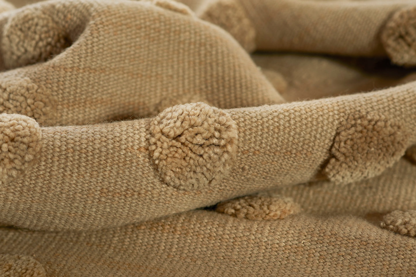 Taupe knit fabric with pom-pom trim; cozy chunky throw blanket.
