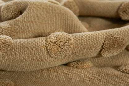Taupe knit fabric with pom-pom trim; cozy chunky throw blanket.