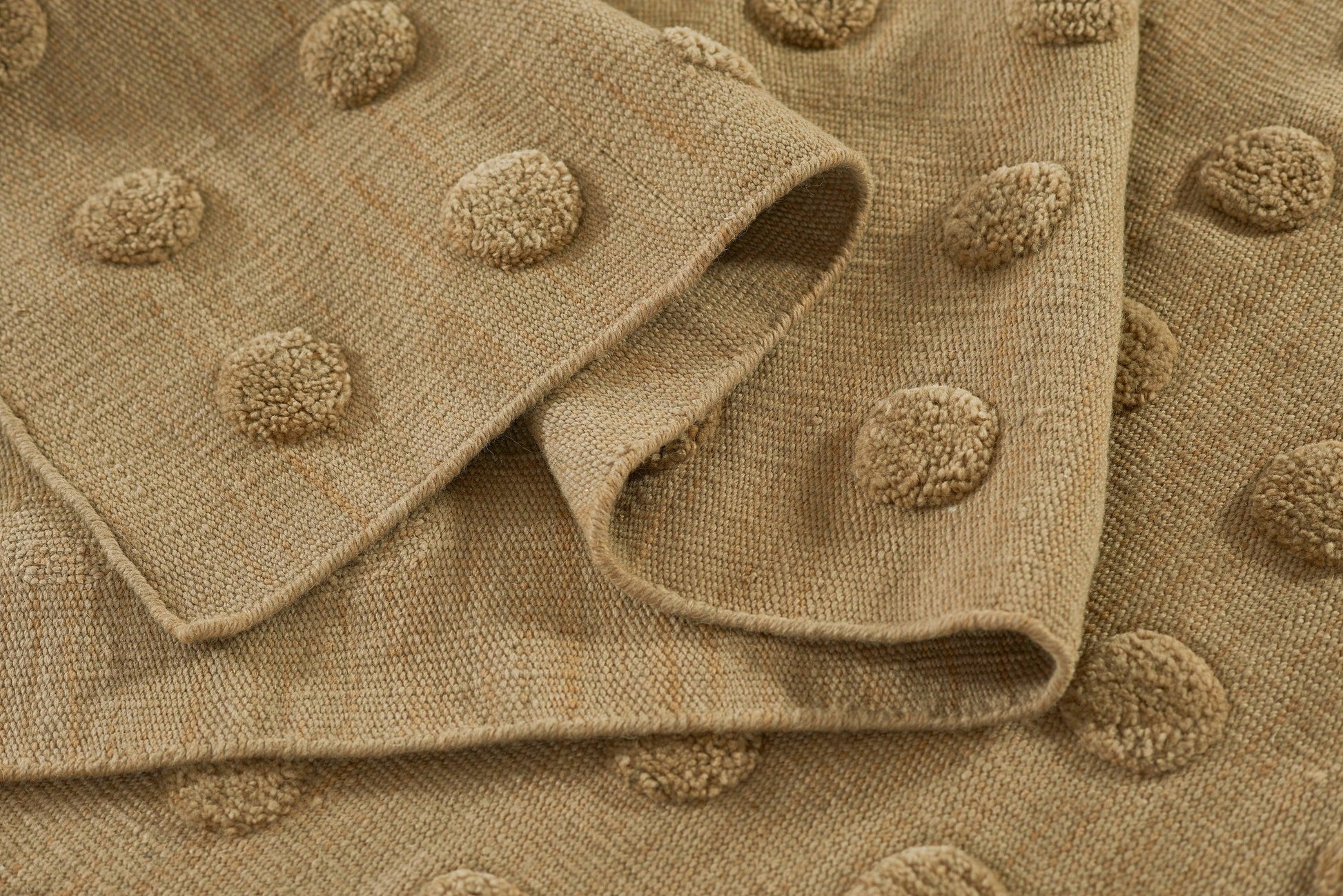 Taupe boucle knit scarf with raised bobble dots and soft woven texture.