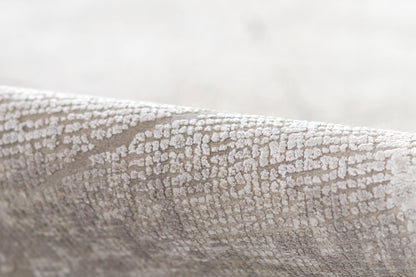 Gray crackle-textured fabric with a subtle raised pattern, ideal for upholstery or decor.