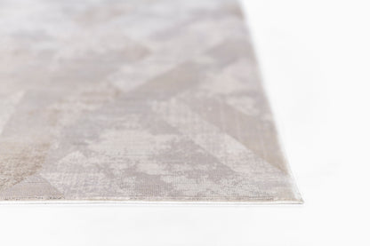 Close-up of a rectangular grey rug with a subtle geometric pattern and woven texture.