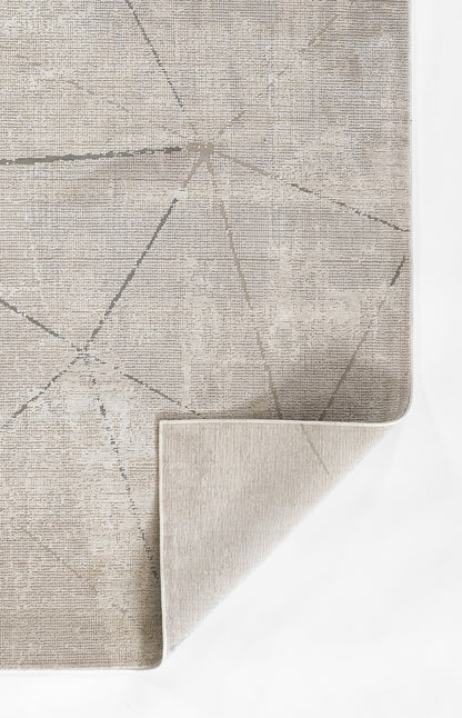 Gray geometric area rug with pale linear pattern; flat-weave look, folded corner reveals beige underside.