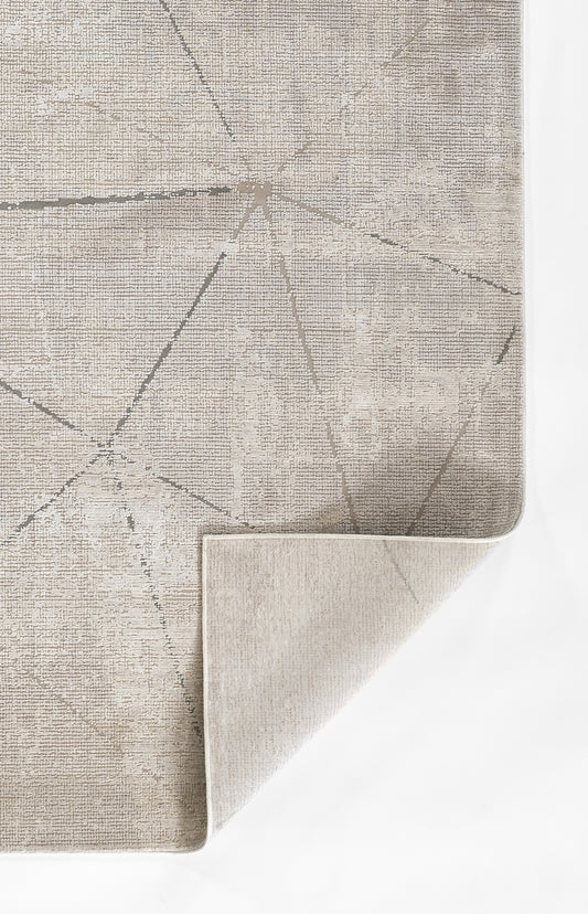 Gray geometric area rug with pale linear pattern; flat-weave look, folded corner reveals beige underside.