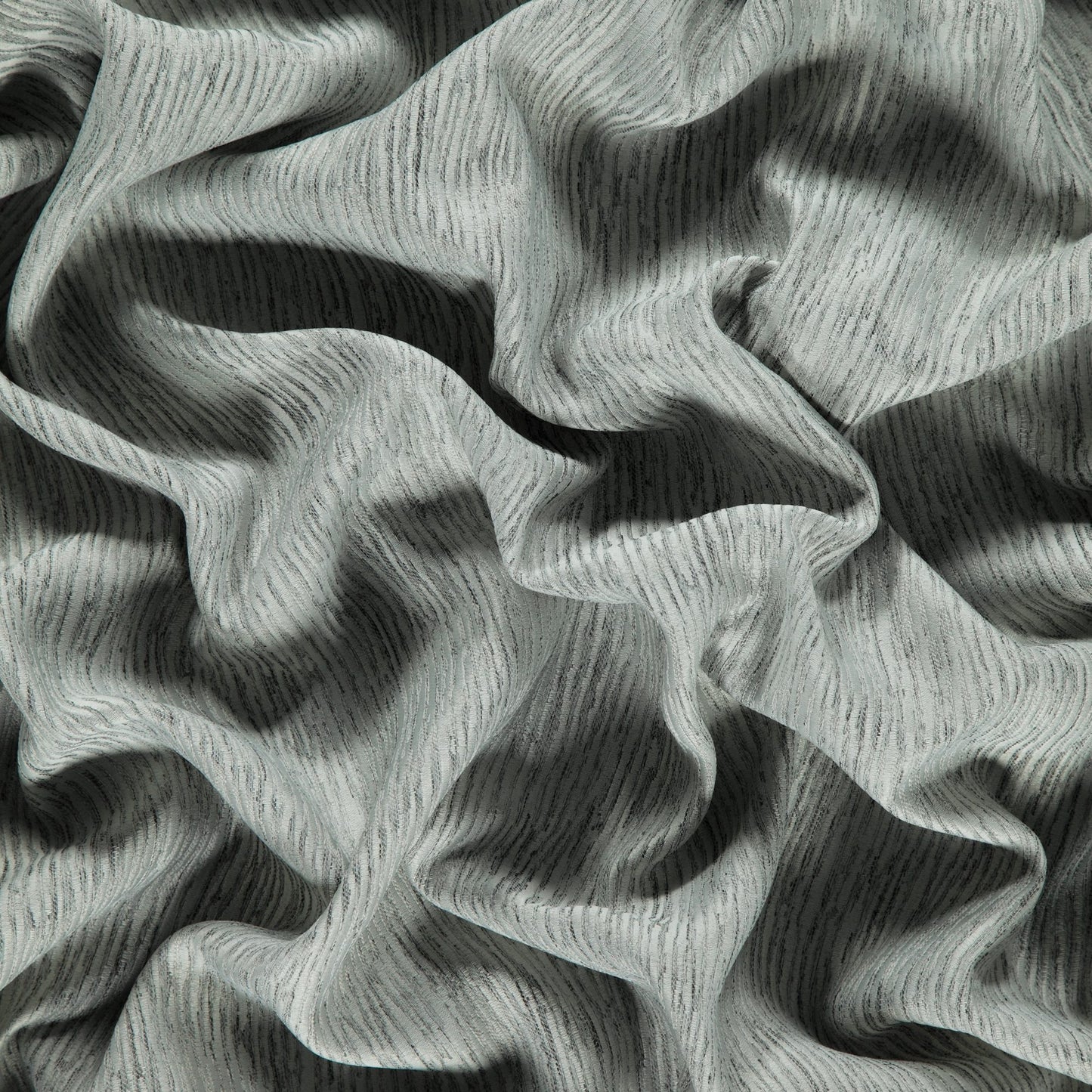 Gray taupe woven jacquard Dimout fabric with subtle texture and soft drape.