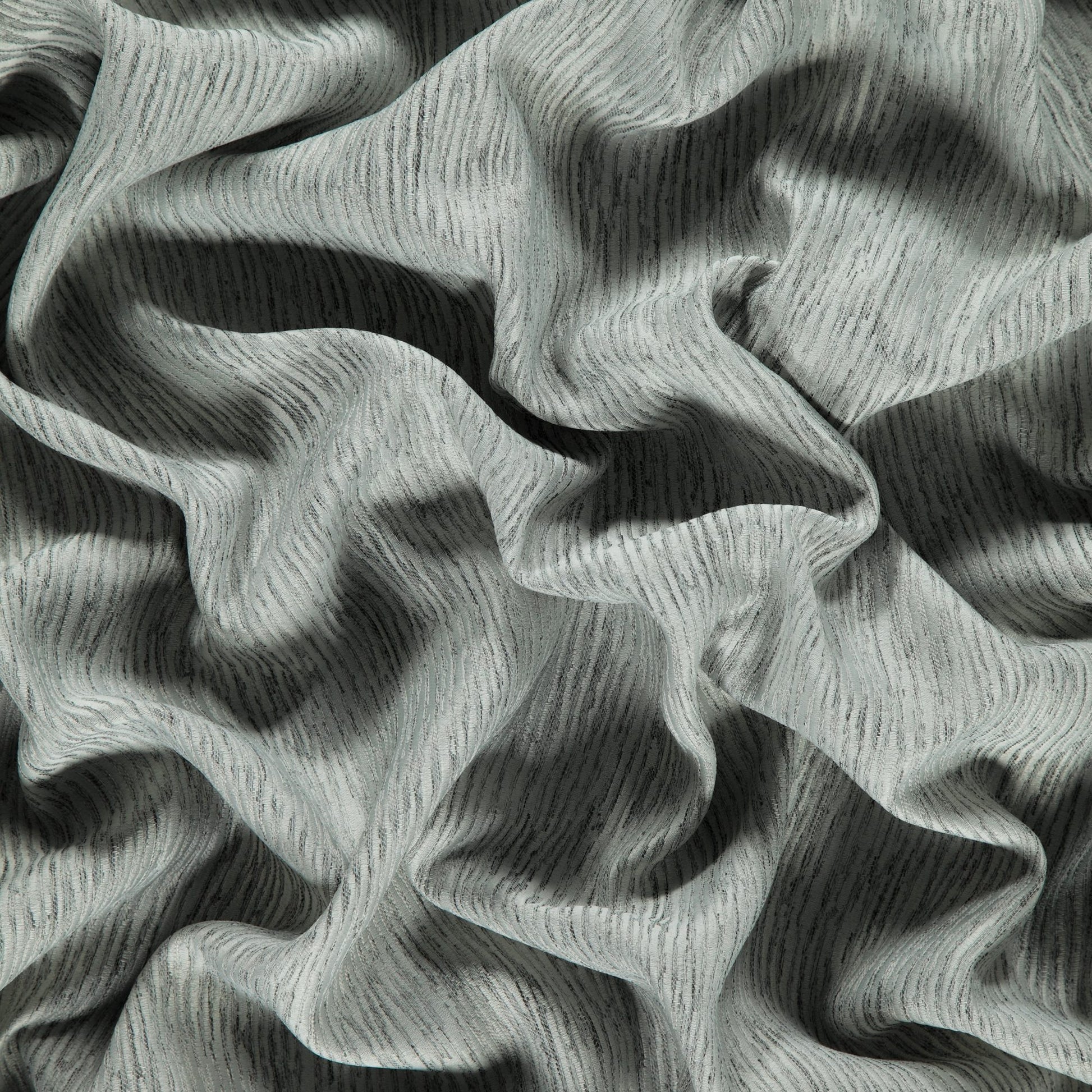 Gray taupe woven jacquard Dimout fabric with subtle texture and soft drape.
