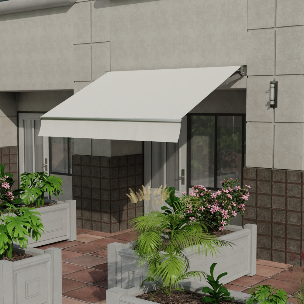 White solid fabric on a retractable awning over a glass door on a gray building, terracotta tile patio with rectangular planters of tropical plants.
