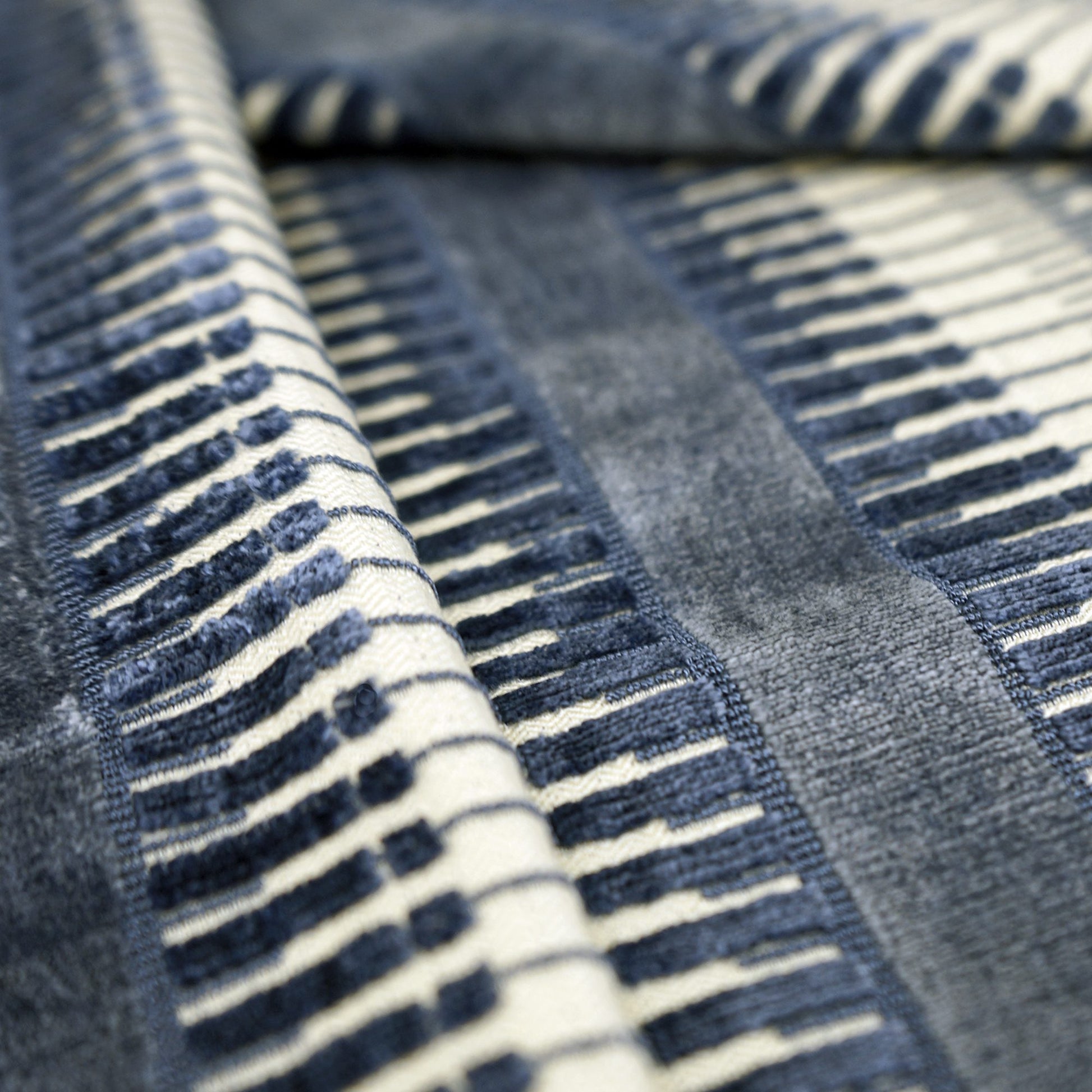 Close-up of navy and white striped velvet fabric with a soft, plush texture.