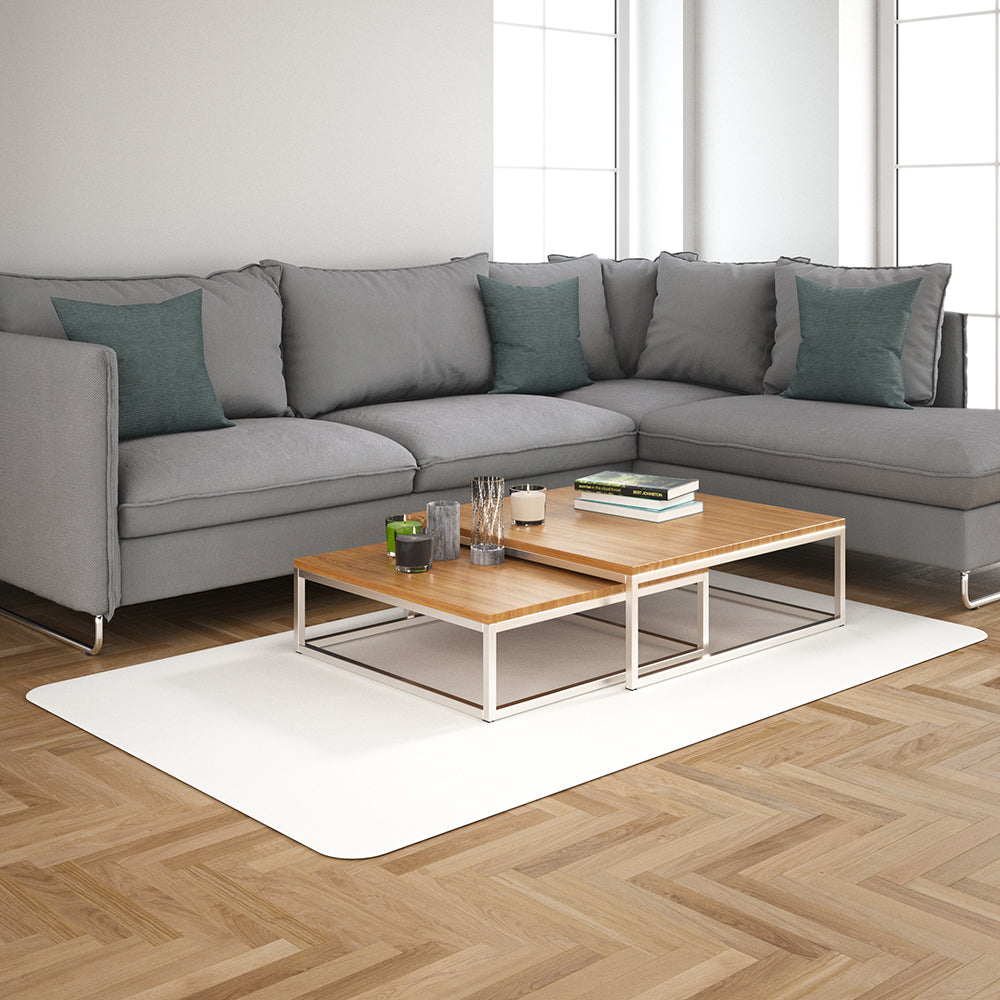 Light-gray L-shaped sofa with teal cushions, two-tier wood-and-metal coffee table on a white rug in a modern living room.