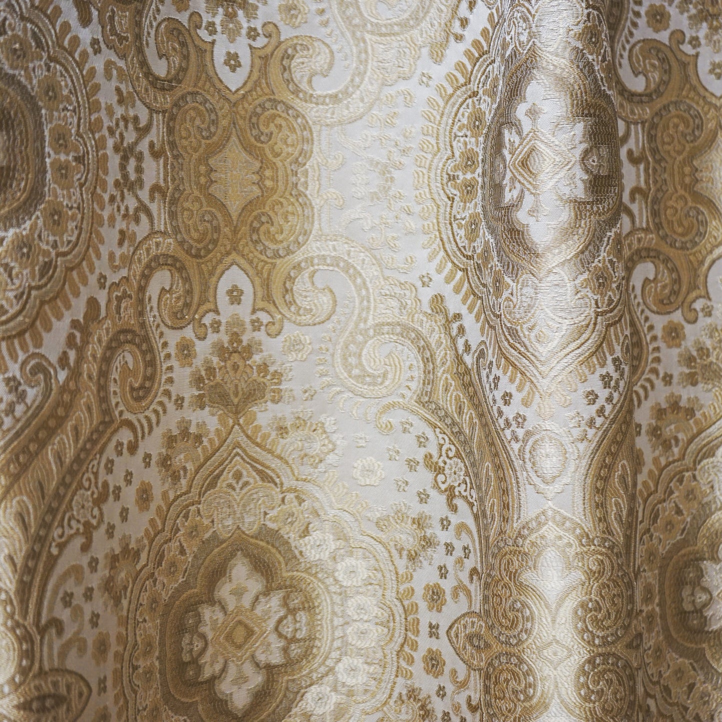 Brown jacquard damask fabric with ornate floral medallions and scrolling motifs.
