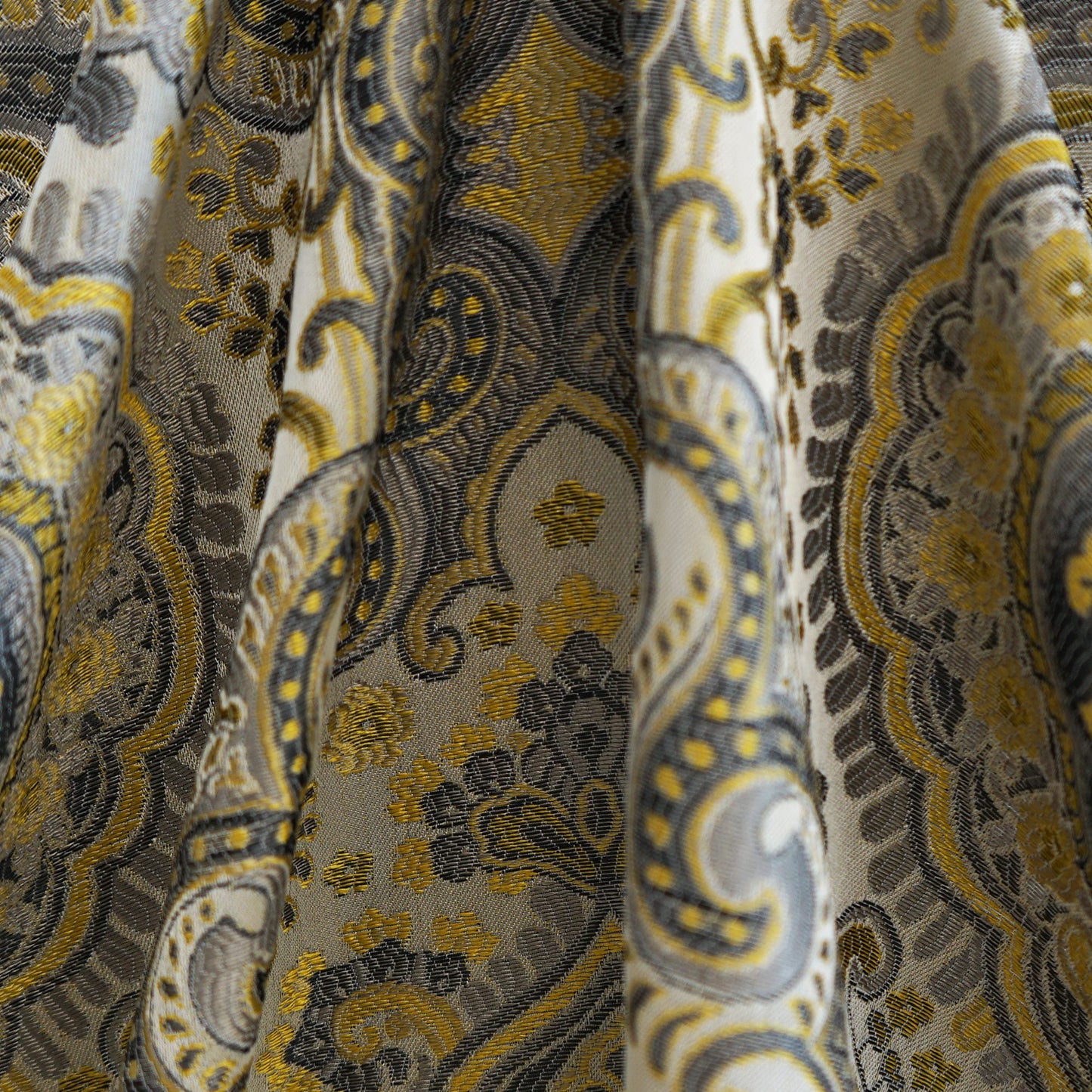 Brown damask paisley jacquard fabric with ornate swirls; luxurious upholstery or curtain material.