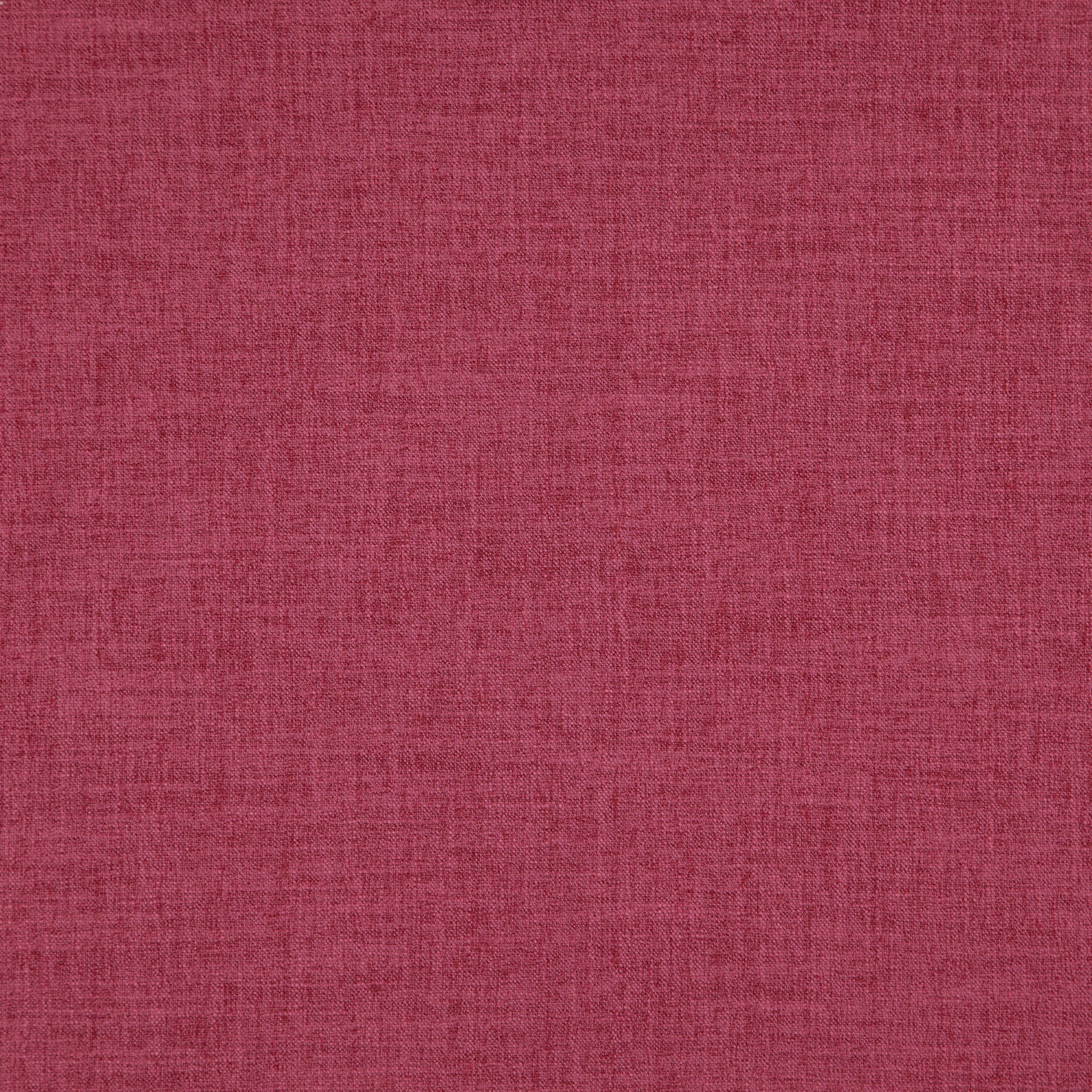 Close-up of pink linen-textured fabric with visible fibers and weave.