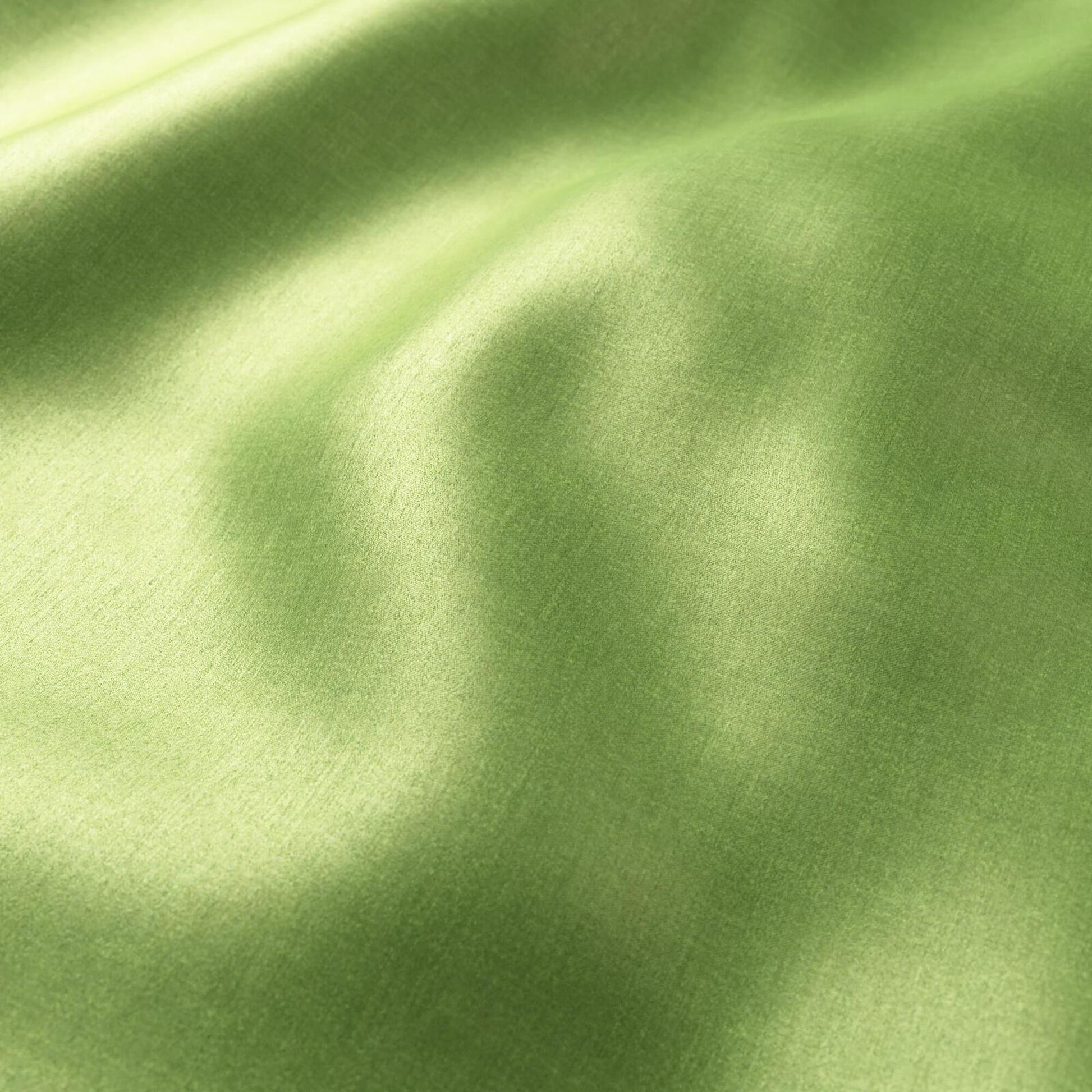 Polished chartreuse green plain sateen fabric with soft folds and silky sheen.
