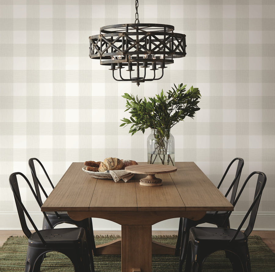 Fog Green Magnolia Home Common Thread plaid wallpaper featuring an oversized check pattern with delicate linen-inspired lines and warm ivory accents. Peel and stick green wallpaper for farmhouse, cottage, traditional, and relaxed modern interiors, including bedrooms, kitchens, bathrooms, dining rooms, and home offices.