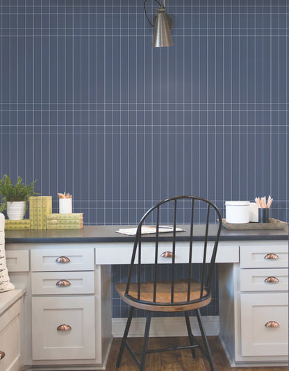 Navy Linear Gridwork geometric wallpaper on a wall in a room.