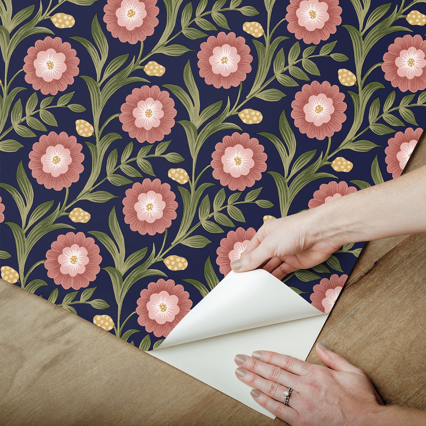 Lillian Blue Floral Vine peel and stick wallpaper by Mirth Studios — rich deep blue background with leafy green vines and pink blooms, non‑woven removable self‑adhesive wallcovering roll, ideal for accent walls in living room, bedroom or nursery.