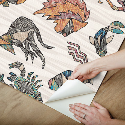 Peel-and-stick wallpaper in multicolor featuring zodiac motifs over flame-stitch background, Missoni PSWP Constellations pattern PSW1644RL.