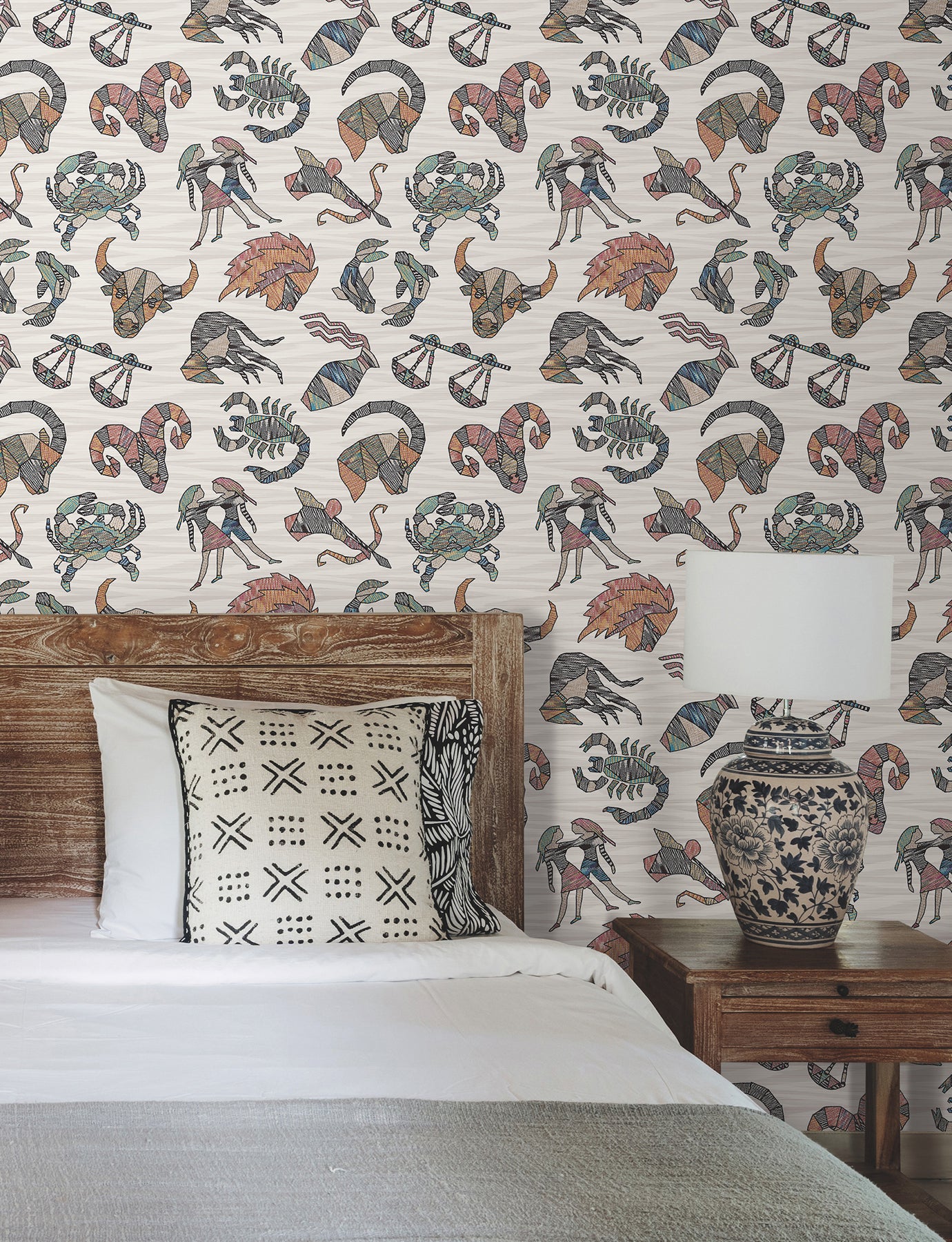 Peel-and-stick wallpaper in multicolor featuring zodiac motifs over flame-stitch background, Missoni PSWP Constellations pattern PSW1644RL.